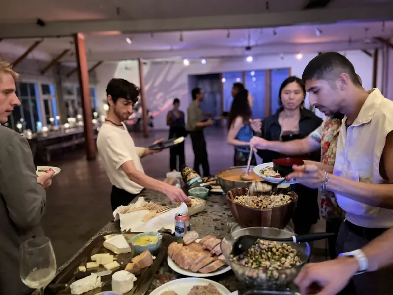 Guests serving themselves from platters laid out on the kitchen counter