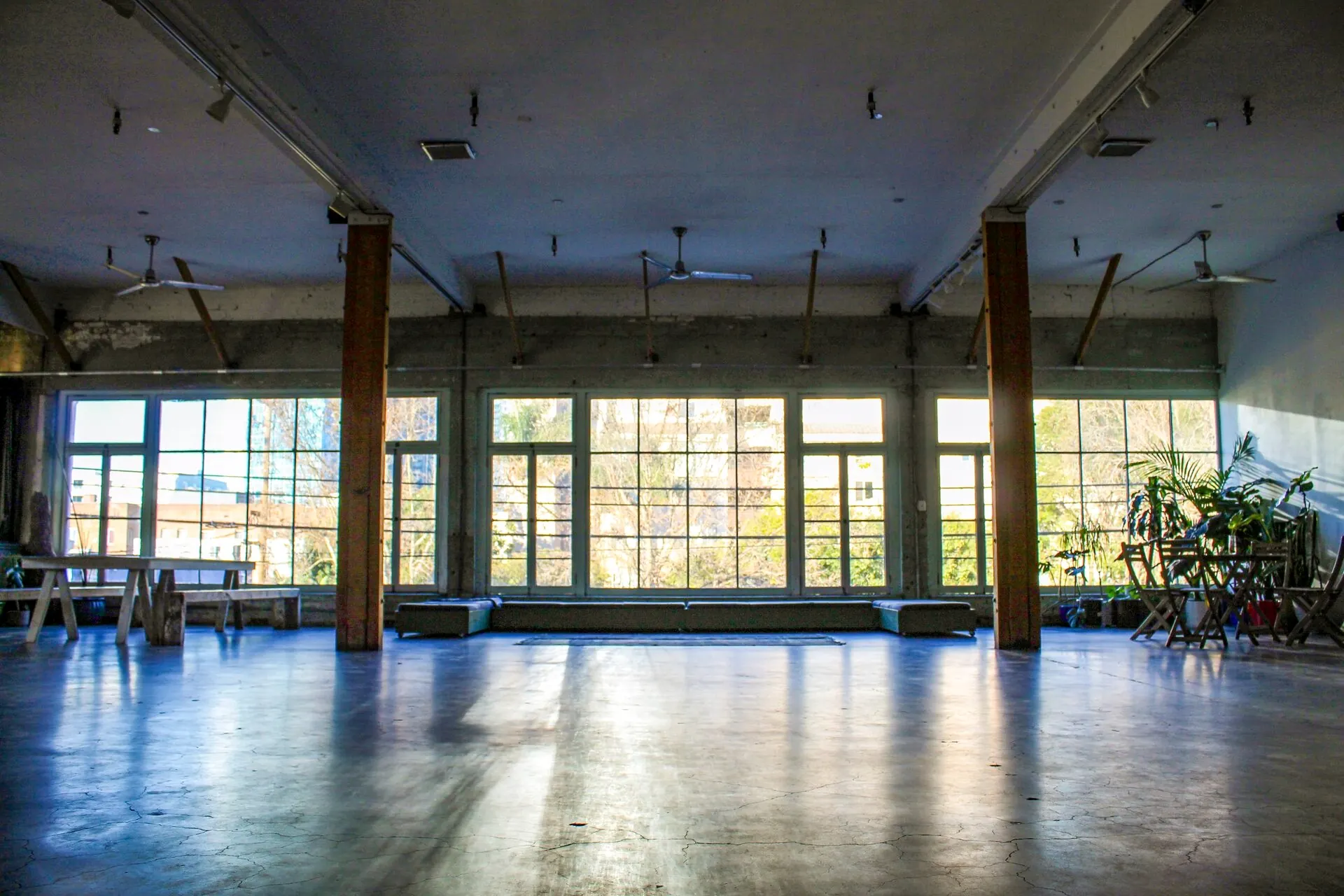The Loft in daylight, with a wall of windows and a polished concrete floor